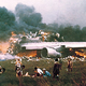 Dazed survivors tend to the injured as flames consume the wreckage of Pan Am Flight 1736 (Author unknown)